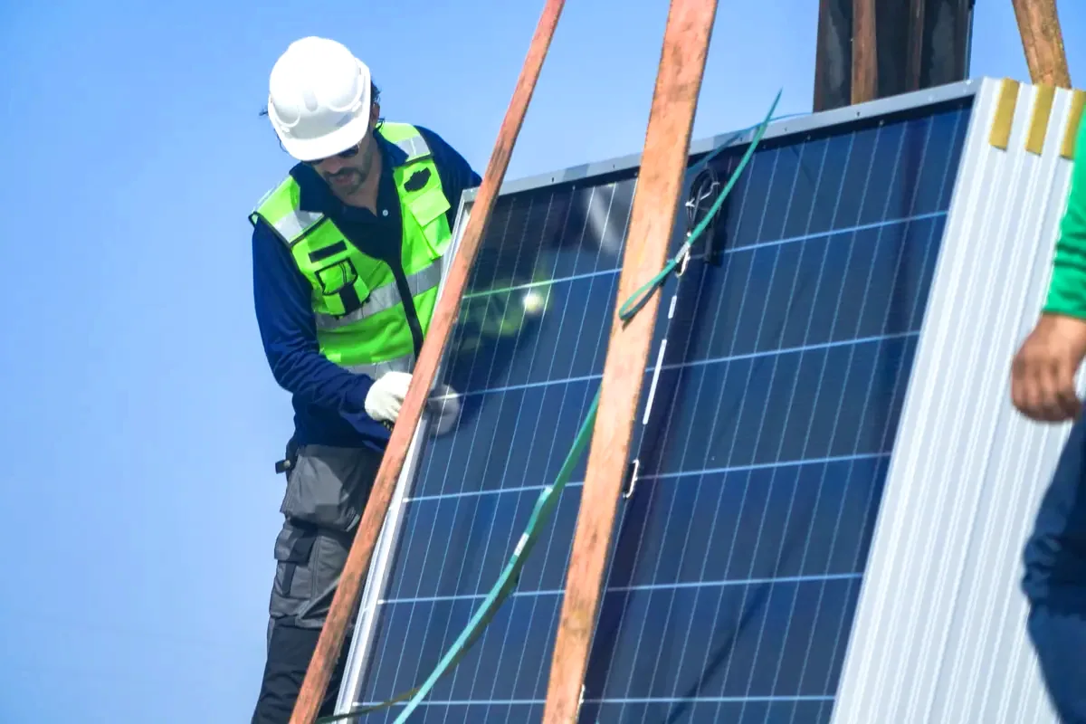 Técnico con casco colocando un panel solar, partida clave al comparar un presupuesto de placas solares en Badalona